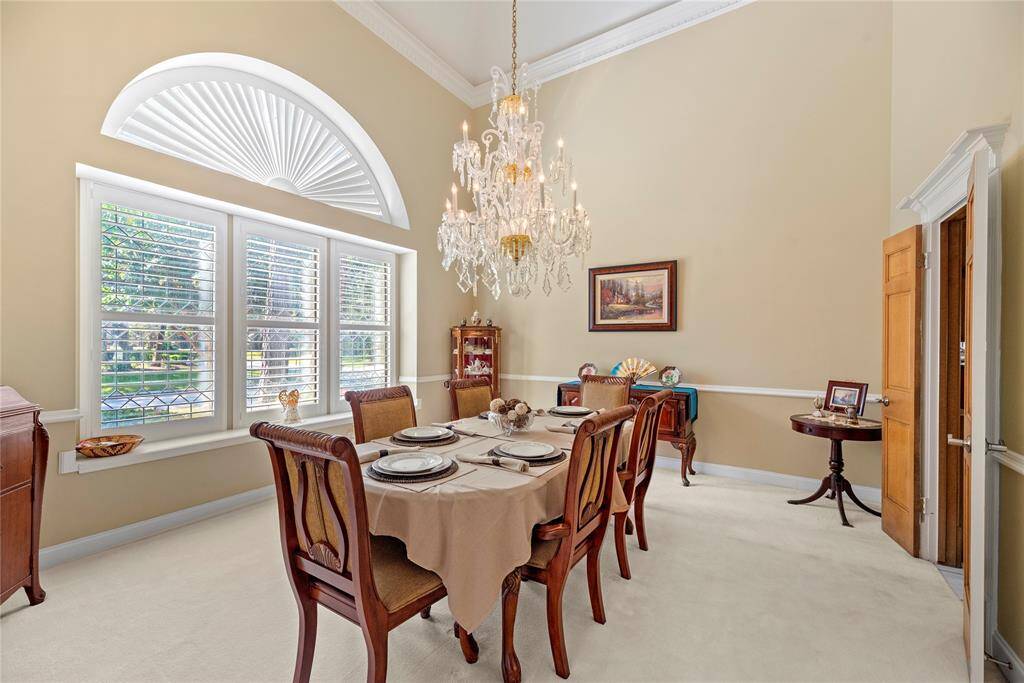 To the right of the entry is your formal dining space. The luxury fixture adds to the upscale atmosphere, with a dazzling chandelier casting a soft, flattering light over the space.