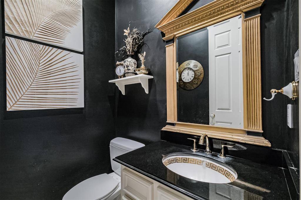EXPERIENCE THE LUXURIOUS RETREAT OF THIS SPACIOUS PRIMARY BEDROOM, FEATURING SOARING CEILINGS, ELEGANT TILE FLOORING, AND A COZY FIREPLACE.