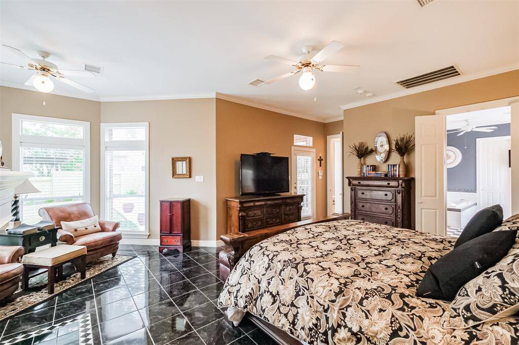 ELEGANT VIEW OF THE FAMILY ROOM FROM THE SECOND-FLOOR BALCONY, FEATURING SOARING CEILINGS, MASSIVE WINDOWS, AND ABUNDANT NATURAL LIGHT.