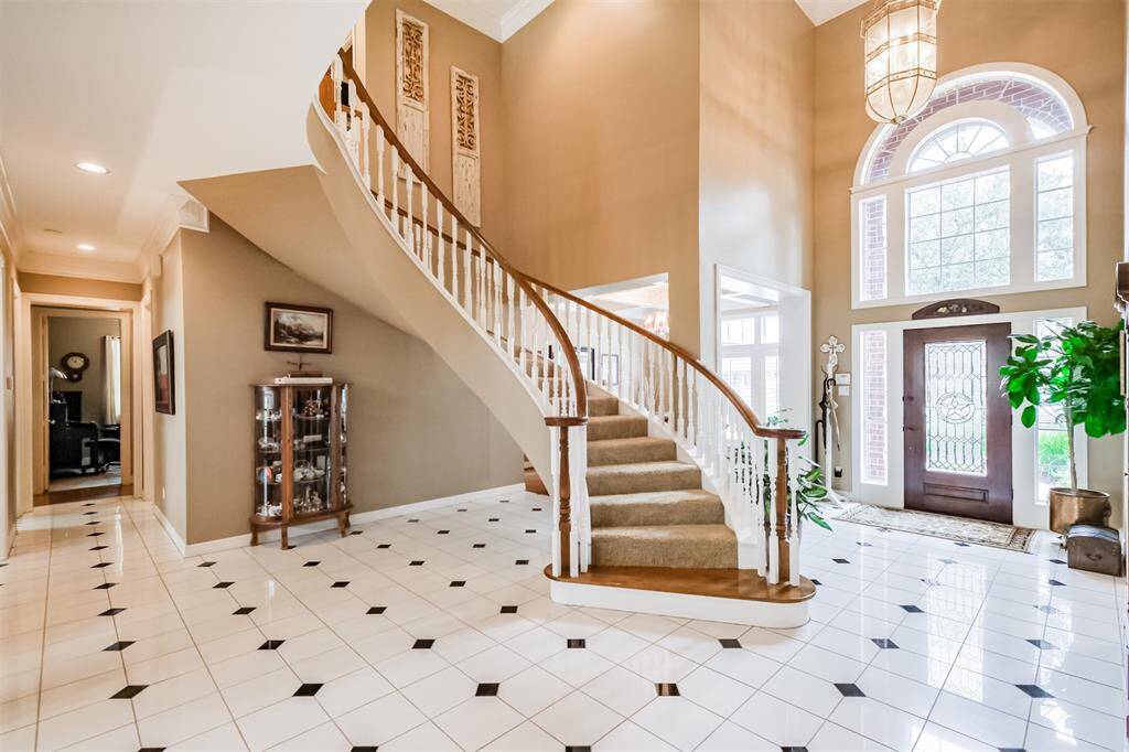 ARCHED DOORWAYS AND COFFERED CEILINGS, THIS SPACE COMBINES ELEGANCE WITH COMFORT.