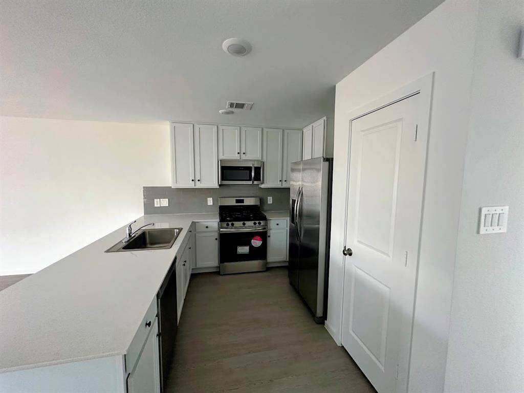 The kitchen includes built-in microwave