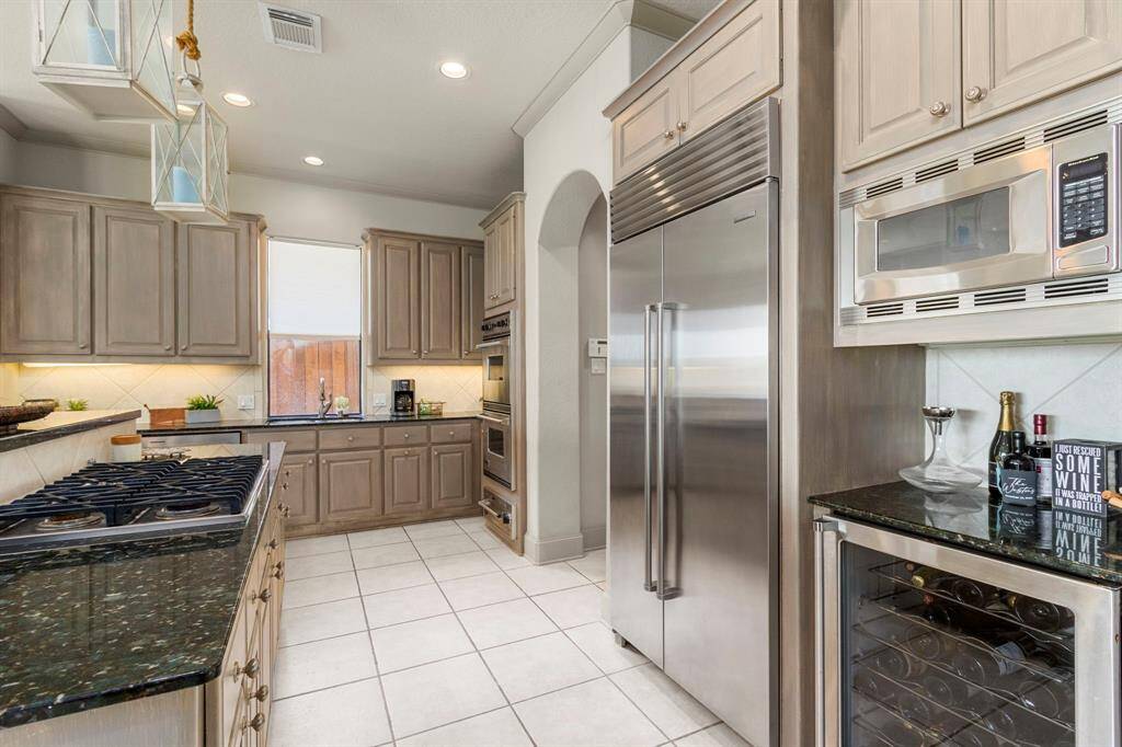 Top of the line Appliances include a Stainless Sub-Zero Refrigerator, Viking Gas Cooktop & Wine Cooler.