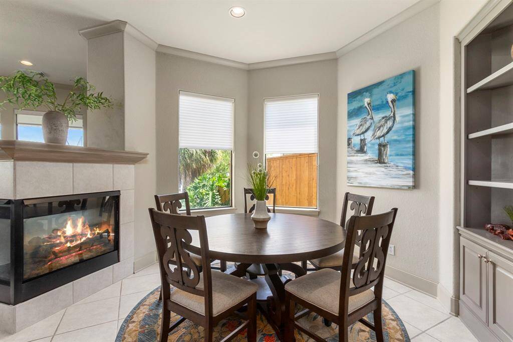 The Breakfast area offers Built-in Shelving and a Cozy Dual Sided Fireplace that Warms up the Area.