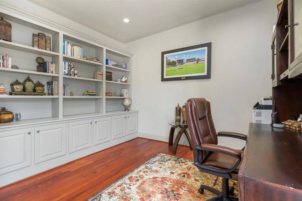 The Private Office offers Built-in Book Shelves and Warm Wood Flooring.