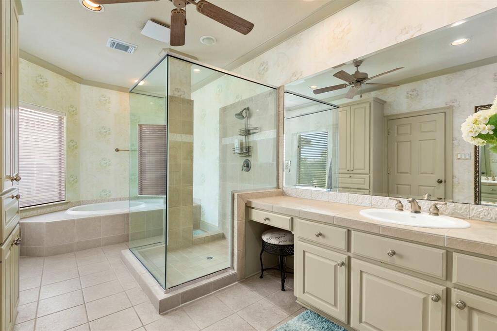The Primary Bathroom offers a Jacuzzi Tub and Glass Walled Separate Shower.