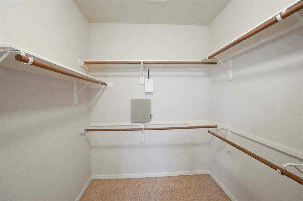 Spacious walk-in closet in the primary bedroom, offering ample storage and organization.