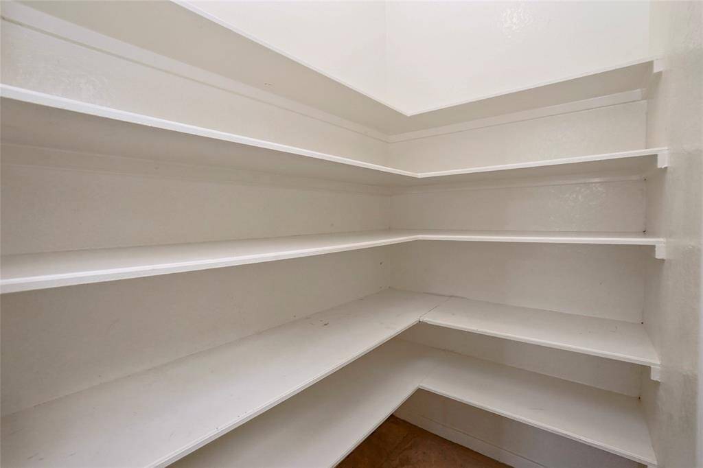 Convenient walk-in pantry with plenty of space for all your kitchen essentials.