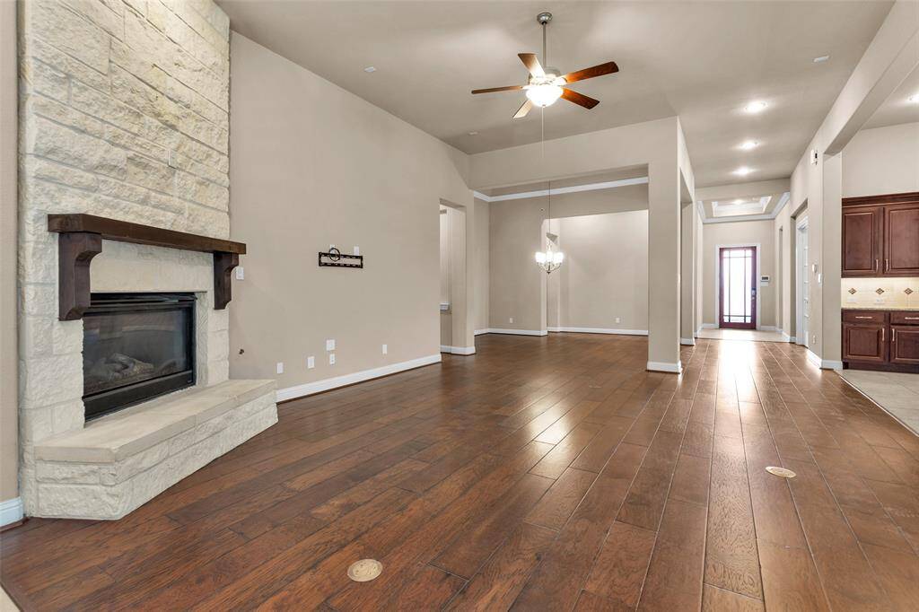 This open living area flows seamlessly into a dining space and kitchen, offering an spacious and inviting layout.. perfect for entertaining.