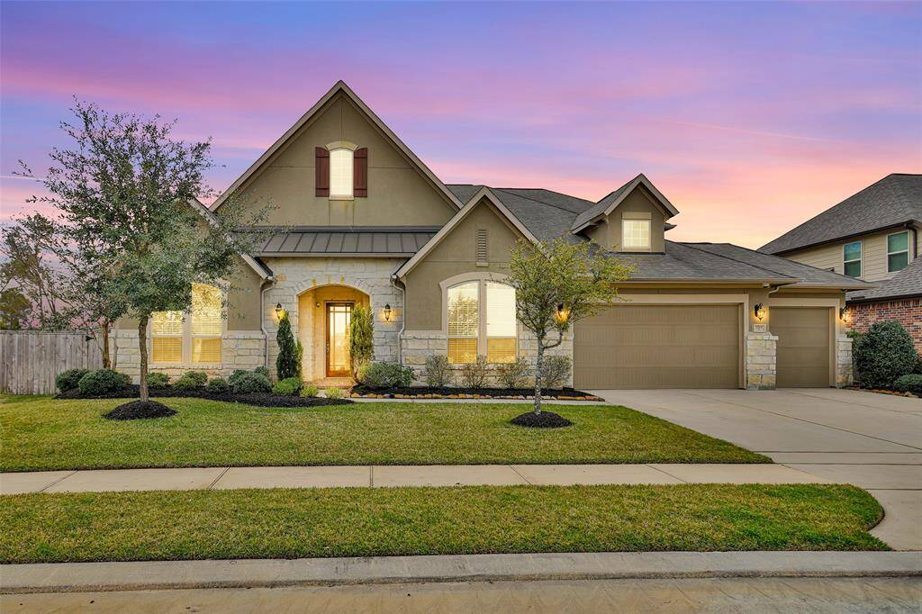 Featuring a 1.5-story home with a well-maintained lawn and a spacious driveway leading to a 4 car garage! The home has a charming exterior with a mix of stone, stucco and brick making for a welcoming entrance.