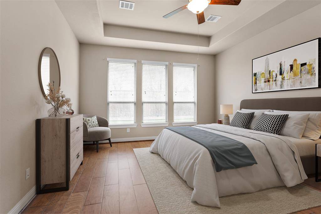 Spacious primary bedroom virtually staged, featuring abundant natural light and elegant design.