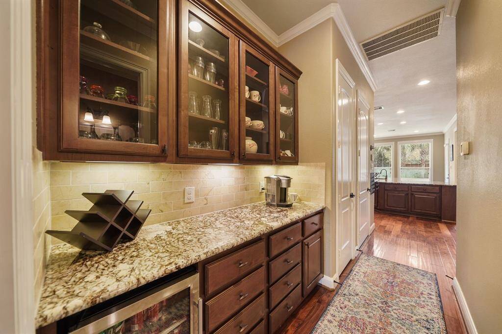 Formal dining has direct access to kitchen through perfectly functional butlers pantry with drink fridge and glass front cabinets