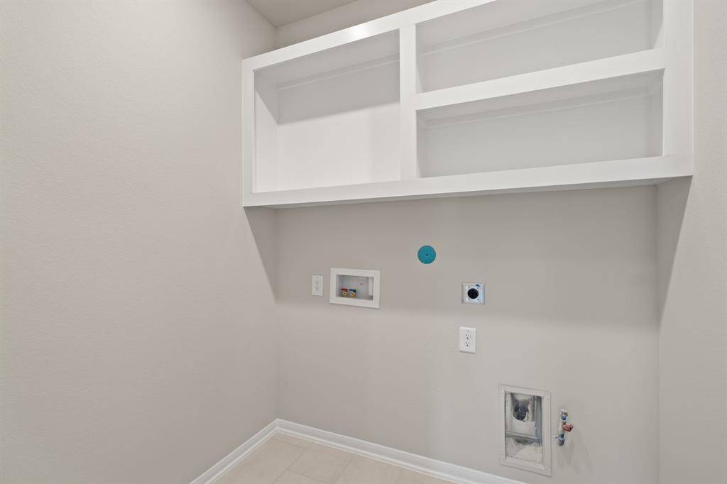 The laundry room layout is carefully planned for optimal workflow with designated areas for washing, drying, and storing.