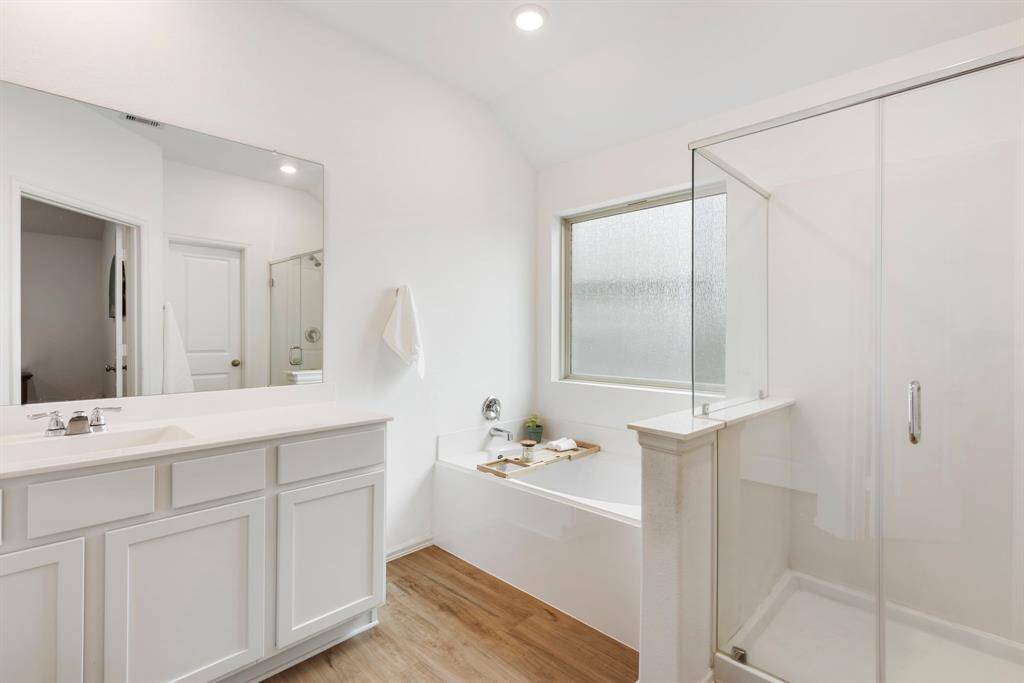 Spacious and elegant master bathroom featuring a walk-in shower, a soaking tub - designed for comfort and relaxation!
