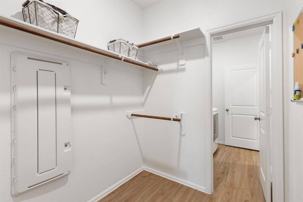 View of the secondary closet connecting the primary room to the laundry room.