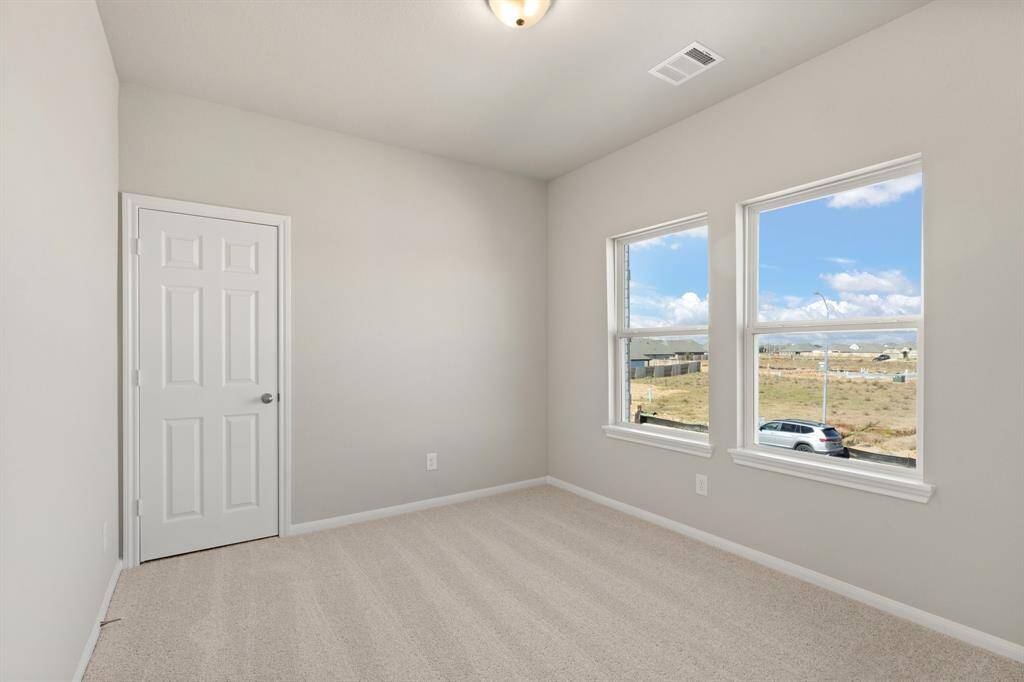 Your secondary bedroom features plush carpet, fresh paint, closet, and a large window that lets in plenty of natural lighting.