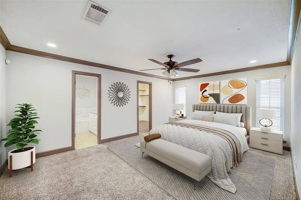 This primary suite is roomy with wood molding, ceiling fan and two long windows for natural light!