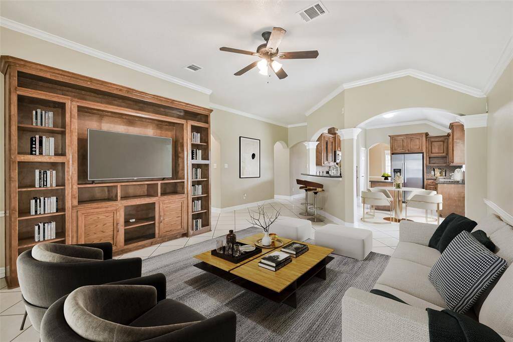 Living room features high ceilings and custom built-in cabinetry