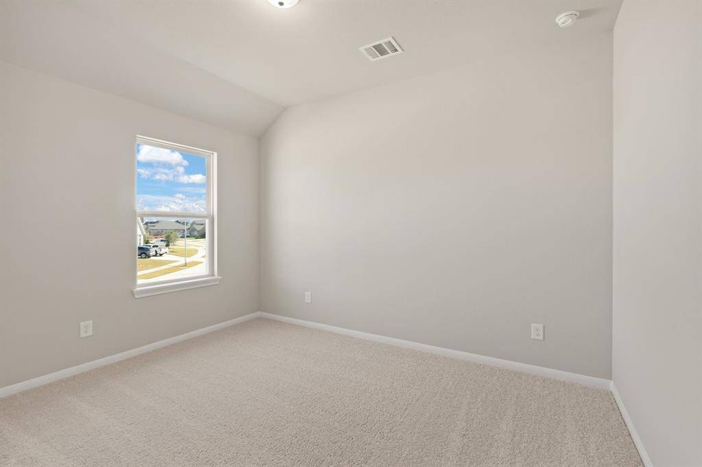 Your secondary bedroom features plush carpet, fresh paint, closet, and a large window that lets in plenty of natural lighting.