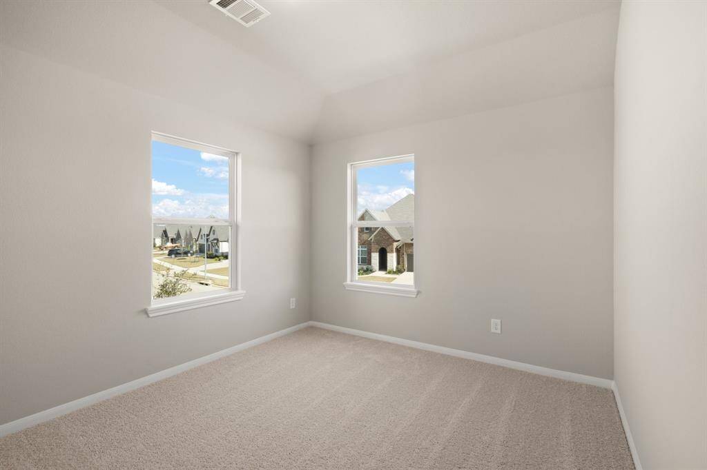 Your secondary bedroom features plush carpet, fresh paint, closet, and a large window that lets in plenty of natural lighting.