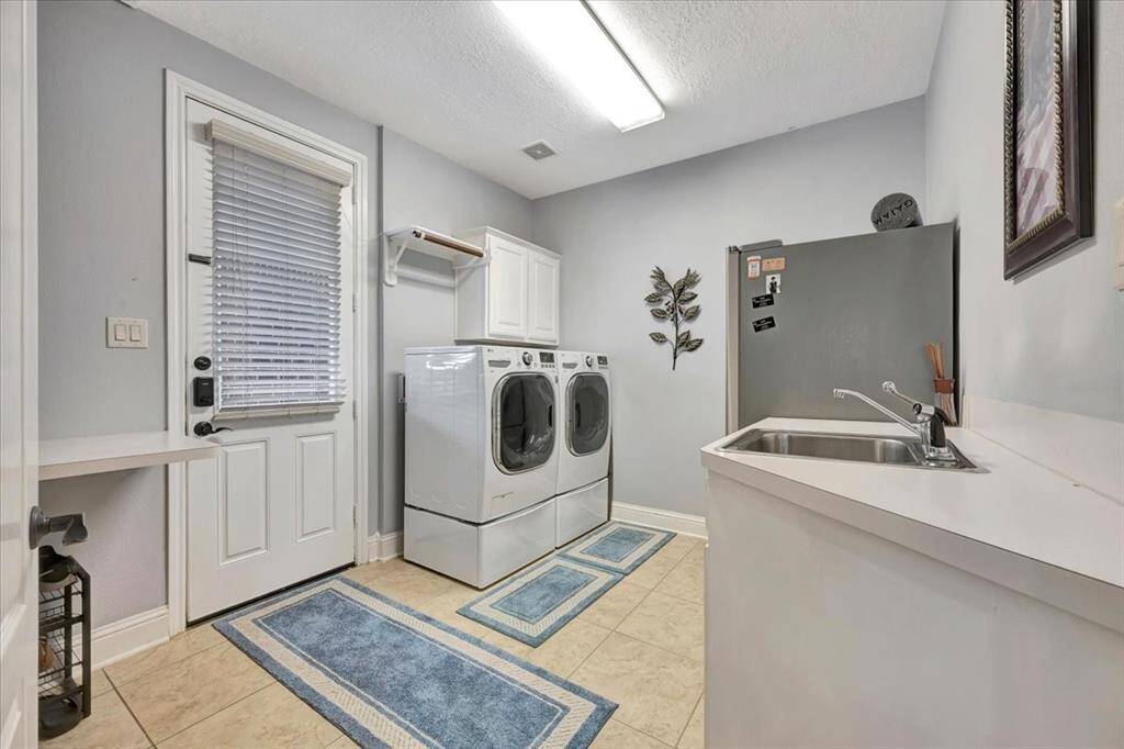 Massive laundry room with sink and extra storage.