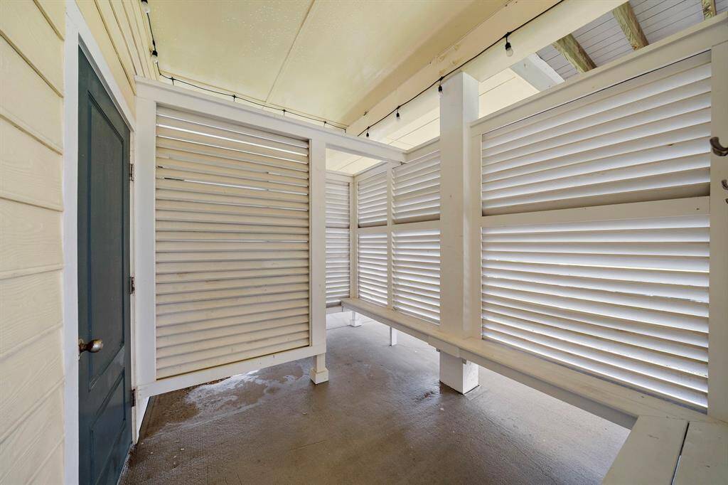 Generous outdoor shower and changing area.  Door on left is the downstairs half bath.