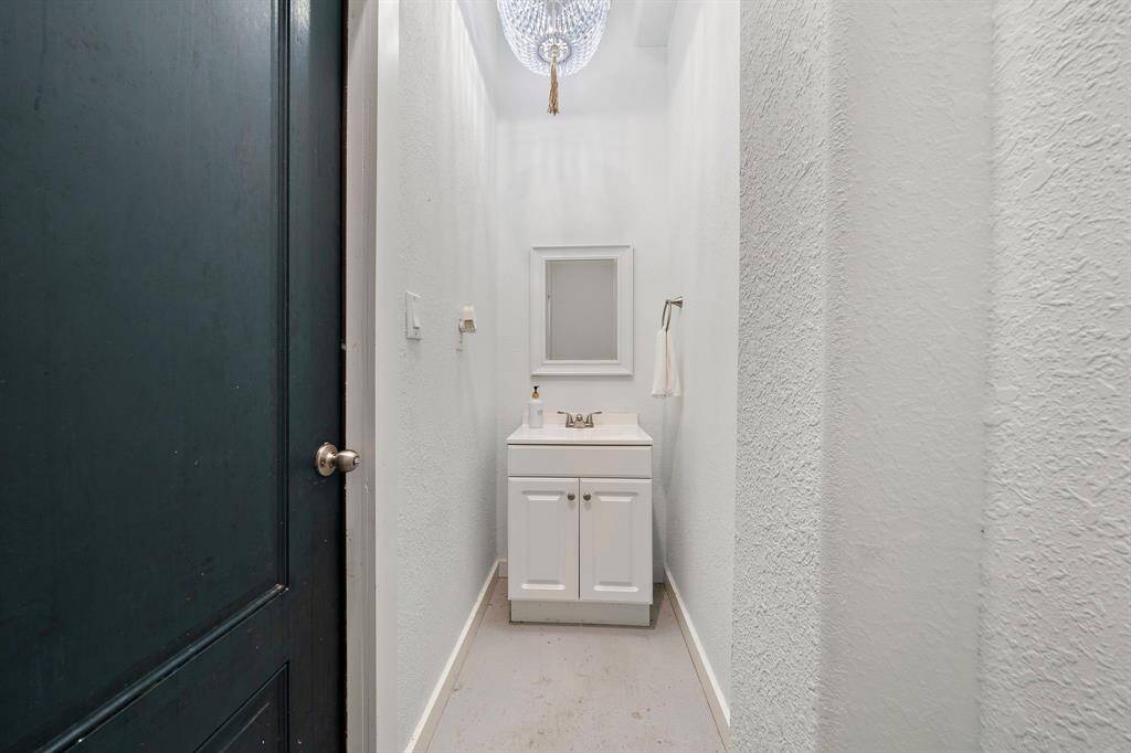 Downstairs bathroom next to the outdoor shower, complete with a chandelier!