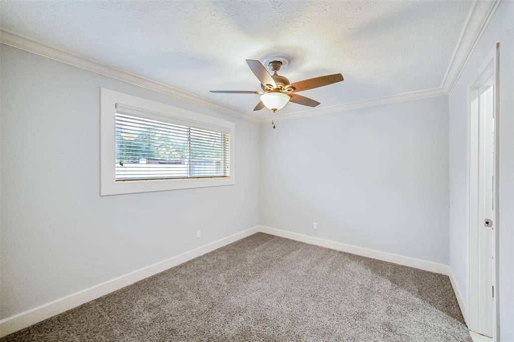 Secondary bedroom.  Attention to detail with crown molding throughout the secondary bedrooms and all are equipt with ceiling fans!