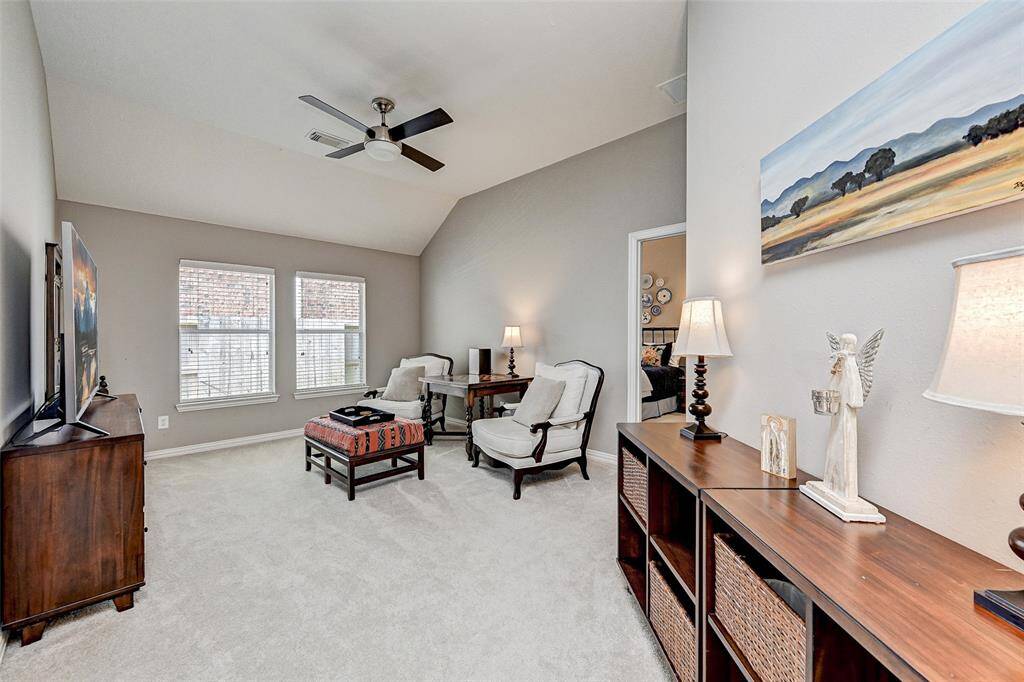 This cozy space is accessible from secondary bedrooms and would serve well as game room, children's play area, TV room, possibilities are countless!  It features neutral walls, plush carpeting, and ample natural light from two large windows.