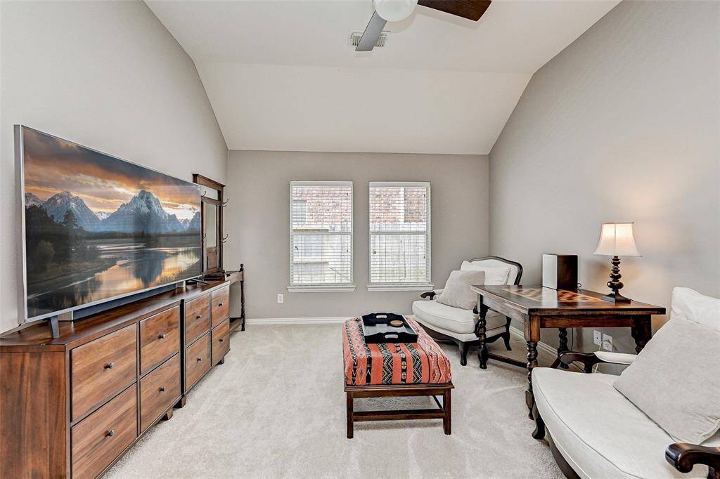 Another view of additional living space.  Bright and spacious living area with vaulted ceiling.  Neutral tones and ample natural light create a welcoming atmosphere.