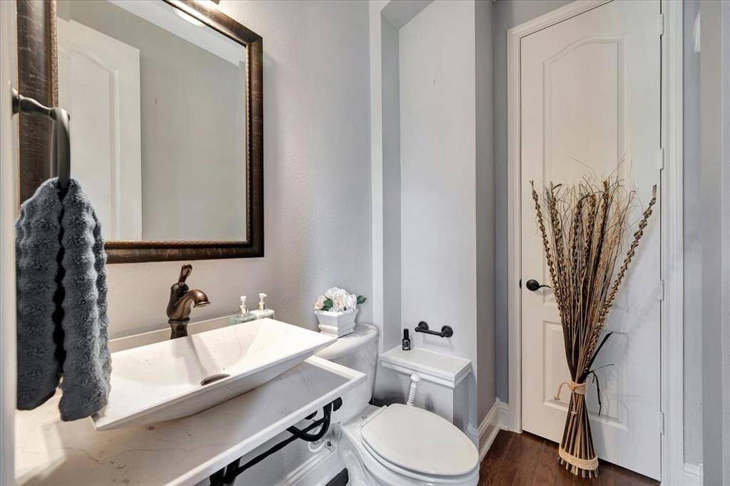 Secluded 1/2 bath just of entrance with easy access to home office.