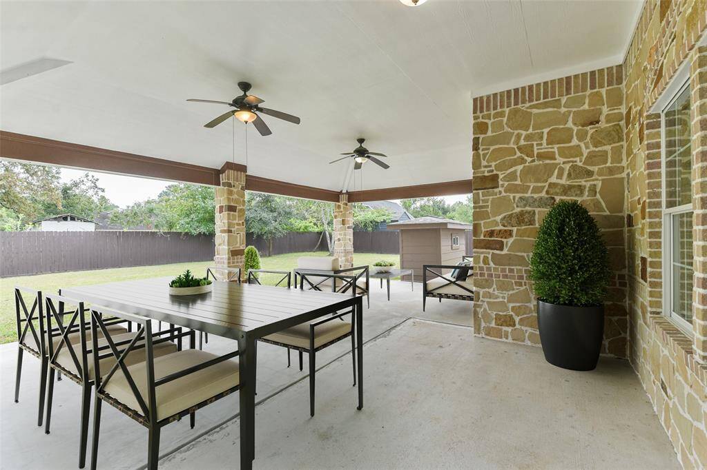 Huge covered patio overlooking a spacious backyard