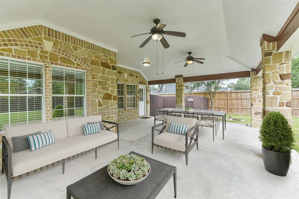 Huge covered patio overlooking a spacious backyard