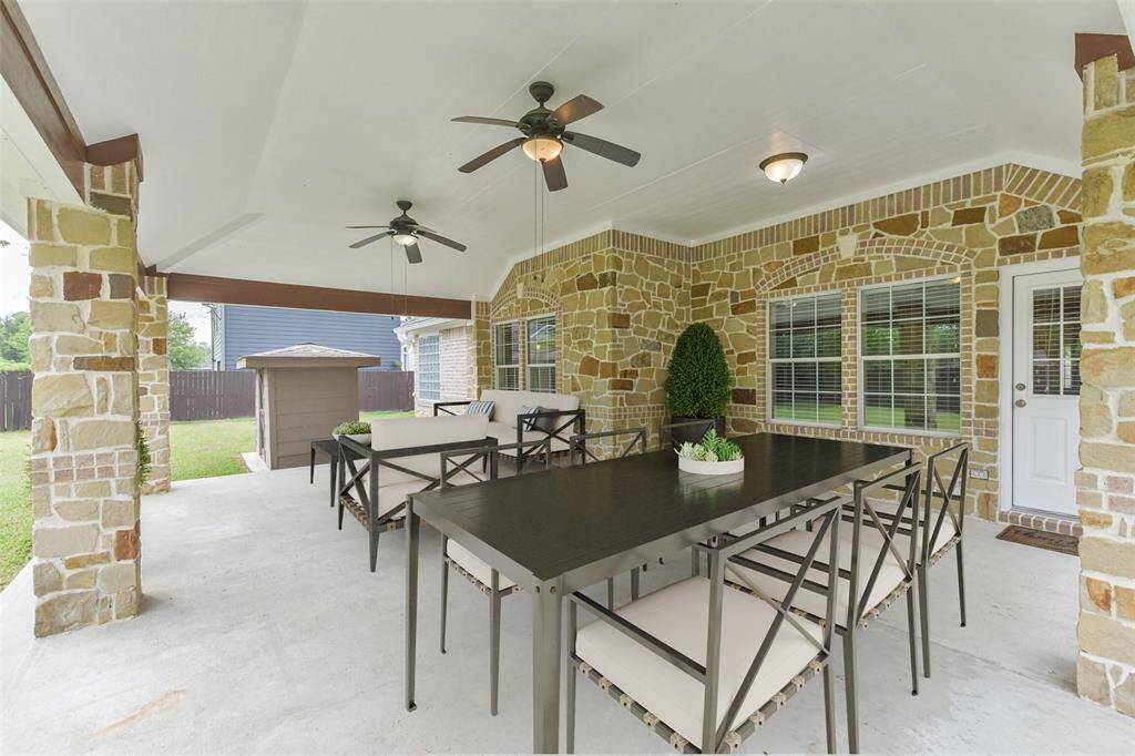 Huge covered patio overlooking a spacious backyard