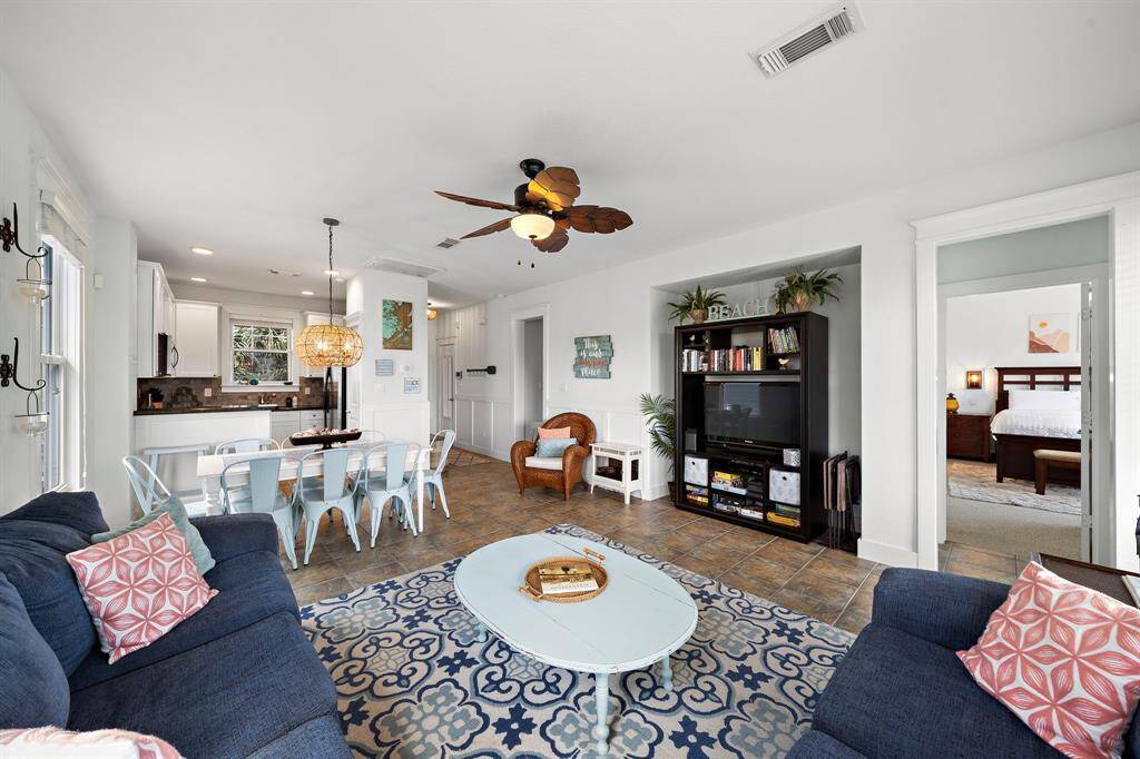 Separate primary en-suite to the right and guest bedrooms on the left, plus a sleeper sofa for additional guests.