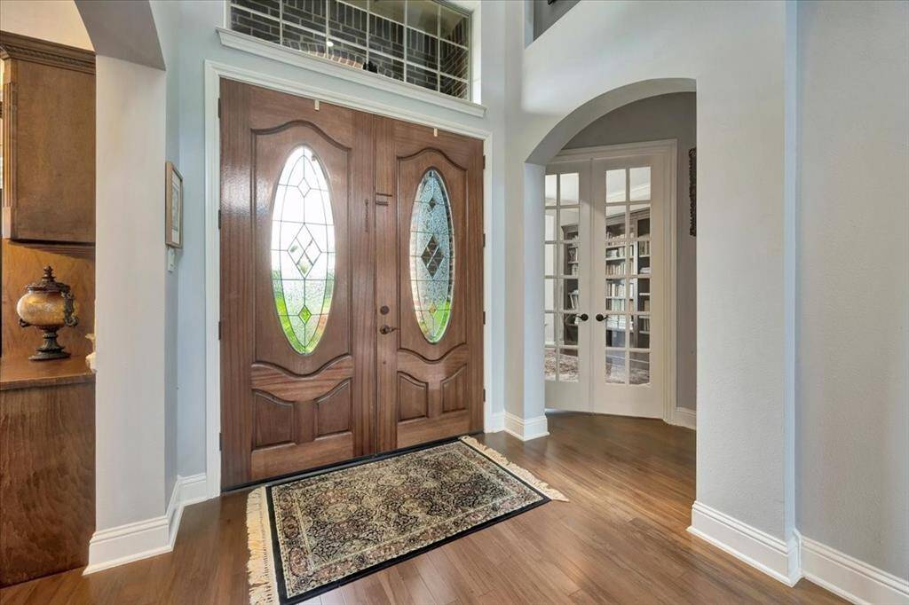 Beautiful front door entrance showing entrance to home office with build in bookshelves.