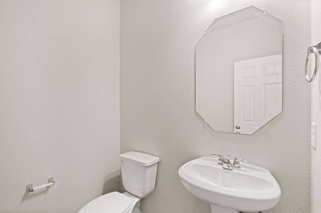 This charming home features a beautifully appointed half bath adjacent to the family room, perfect for welcoming guests and adding convenience to your daily life.