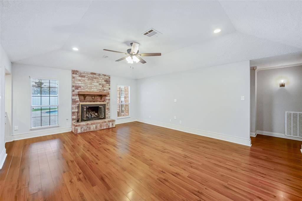 Tons of natural light with a beautiful brick gas log fireplace!