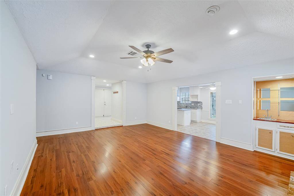 Another view of the large family room with a built in bar area that could be repurposed for storage or shelves!