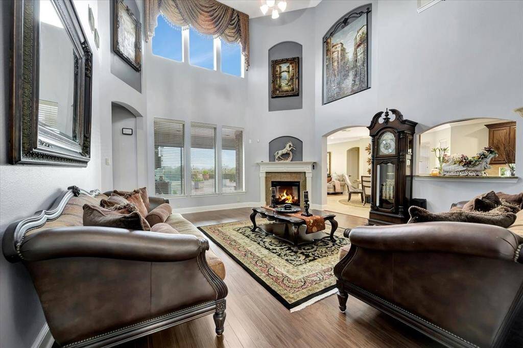 Large living room is the center home home and has fireplace and beautiful view of pool
