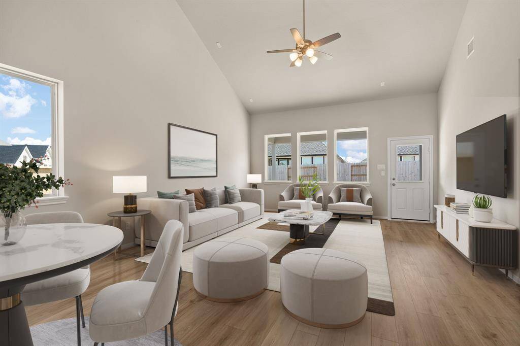Your family room has ample space to entertain family and friends. This space features beautiful floors, fresh paint, ceiling fan with lighting, and high ceilings.