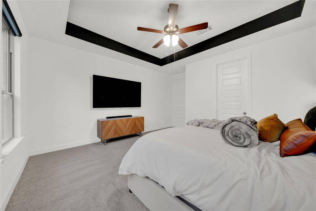 Primary room with accented tray ceilings