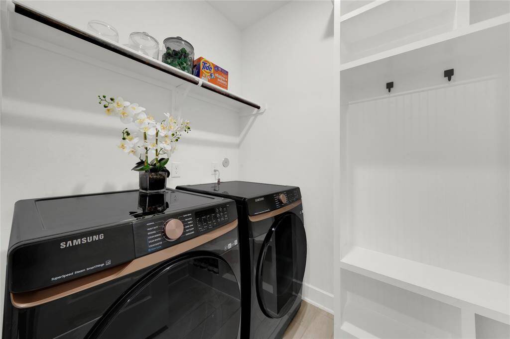 Laundry room has a built in storage/mud area and motion sensor lighting