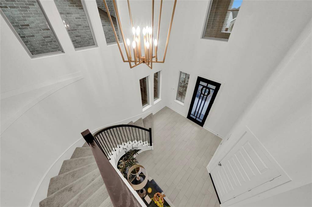 A gorgeous grand rotunda and striking chandelier greet you as you enter this like-new home which provides a great view from above.