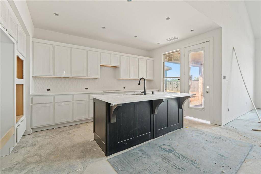 Heart of the home, this open-concept kitchen flows seamlessly into the family room.