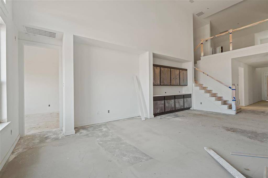 The family room showcases double windows to allow natural light to pour in, brightening the entire space.