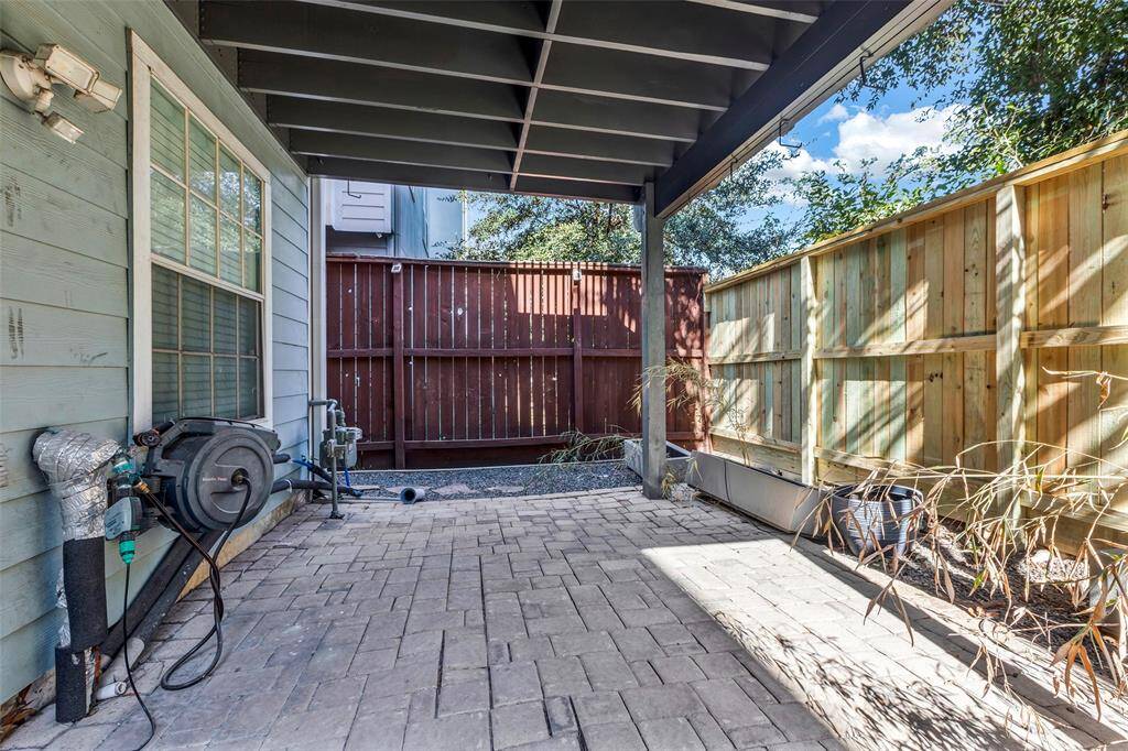 This is a modern 3 story townhome with a brick facade, featuring a garage and large windows, situated in a row of similar homes under a clear blue sky and in the best location! In the heart of Midtown.
