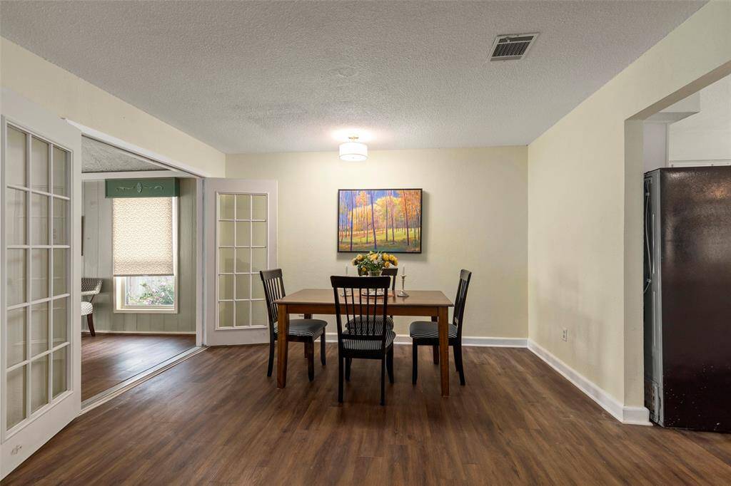 Dining area with easy access to the kitchen and French doors to the sunroom.
