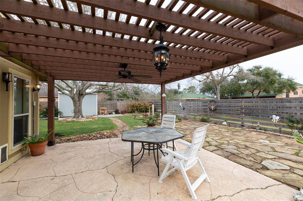 Beautifully landscaped backyard with shed for extra storage.
