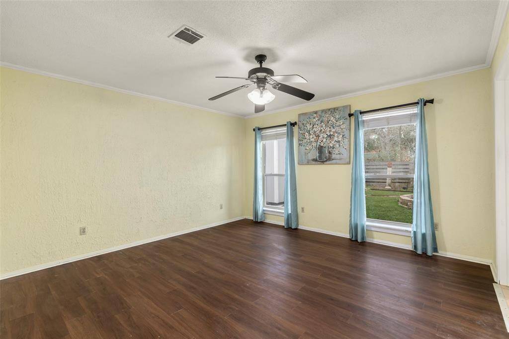 Primary Bedroom with ceiling fan, views to the backyard.