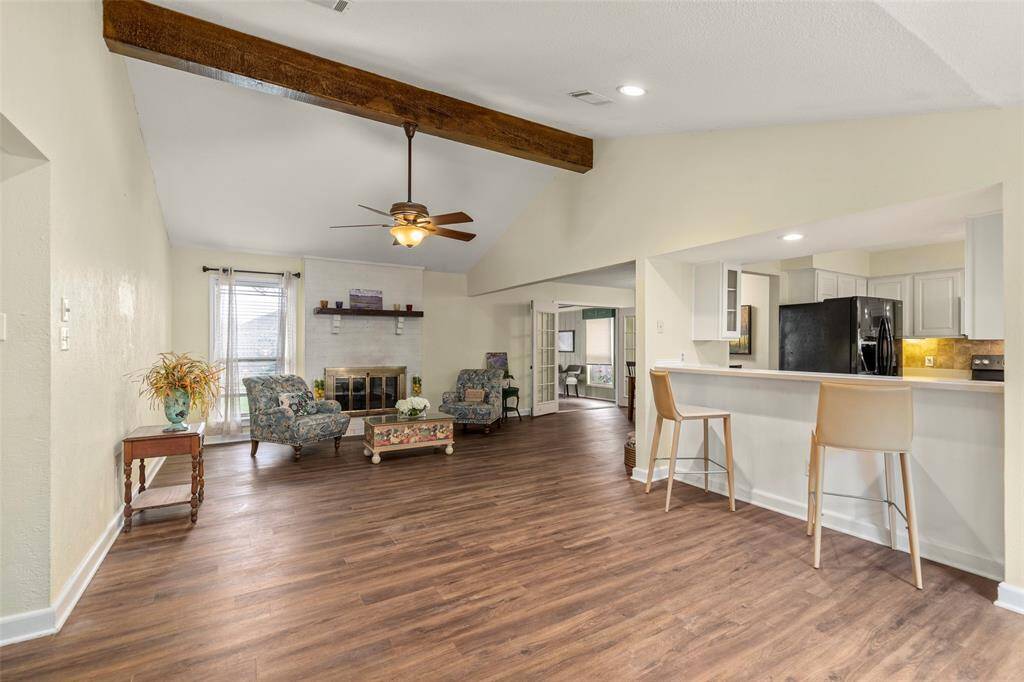 Open floor plan with vaulted beamed ceiling.
